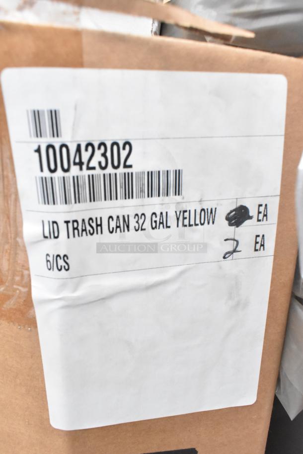 Cardboard box with label reading "Lid Trash Can 32 Gal Yellow" and barcode 10042302. Box contains six units.