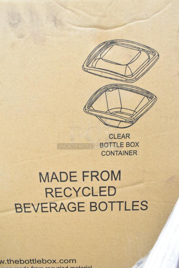 Cardboard packaging for Sabert clamshells, label indicates made from recycled beverage bottles.