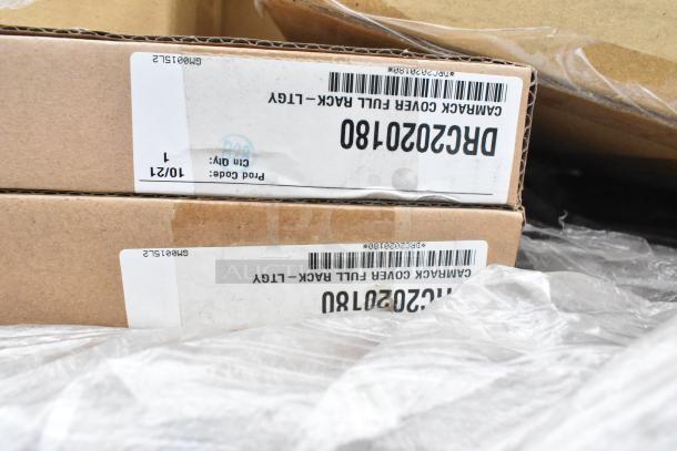 Cardboard boxes labeled “GAMARACK COVER FULL RACK” for auction of 19 new scratch and dent items, including Sabert clamshells and metal pans.