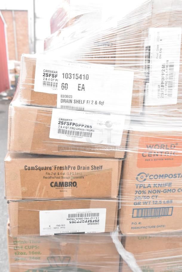 Stacked boxes of brand new items including Cambro CamSquare drain shelves, World Centric compostable knives.