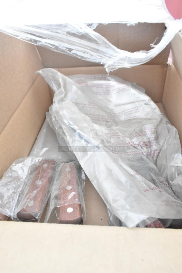 Box containing various new scratch and dent items, including knives with wooden handles in plastic wrap.