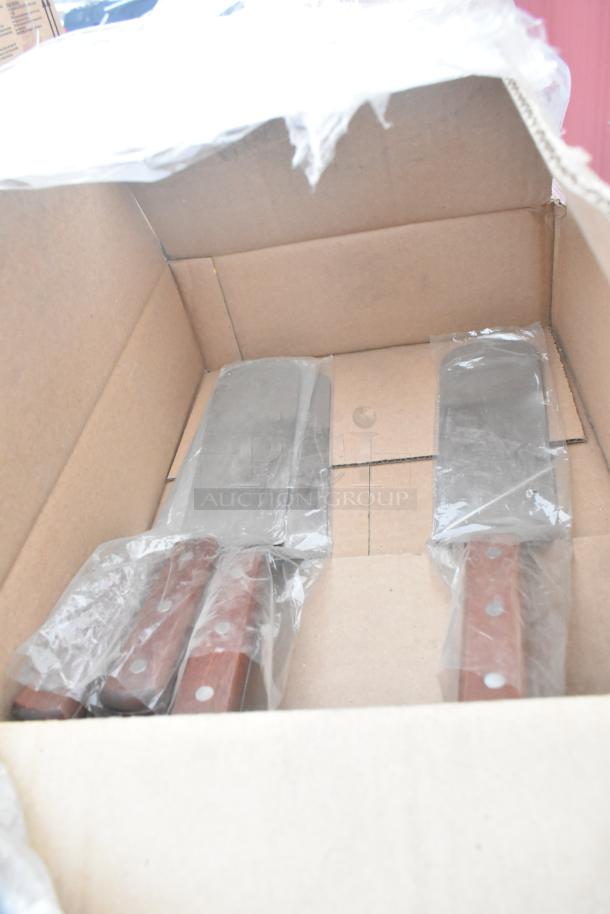 Cardboard box containing unbranded knives with wooden handles, wrapped in plastic, part of a scratch and dent auction.