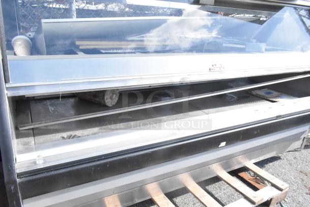 Commercial floor style warming display case merchandiser, glass front, metal shelves, good condition, ideal for showcasing food items.