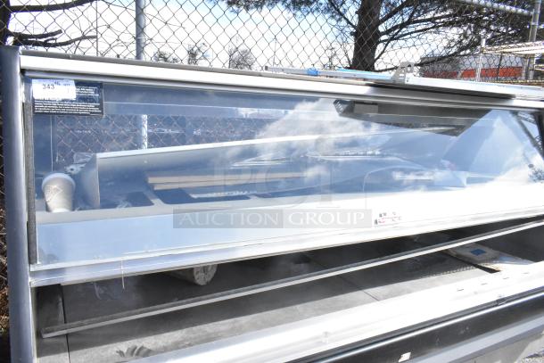 Commercial floor style warming display case merchandiser with stainless steel frame, large glass front, and interior shelving, in used condition.