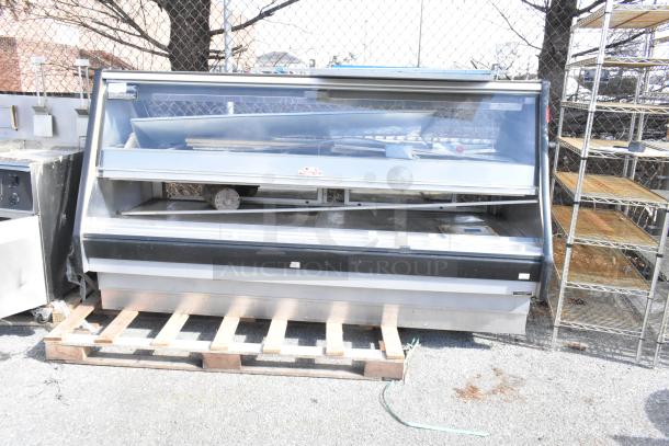 Commercial floor-style warming display case; stainless steel with glass front; used condition, suitable for merchandising.