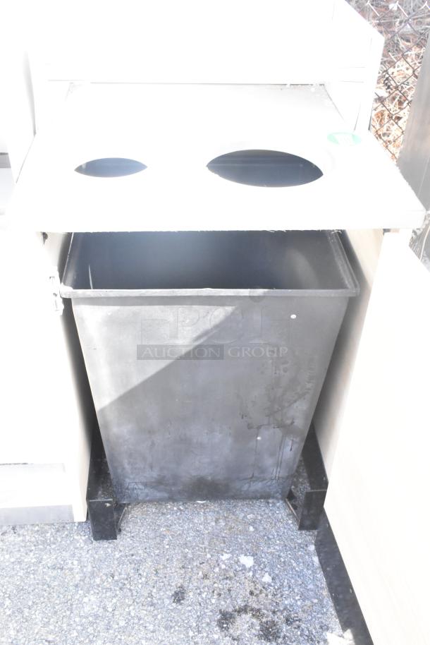 Black trash can shell with dual openings, sturdy build, minimal wear, suitable for commercial use.