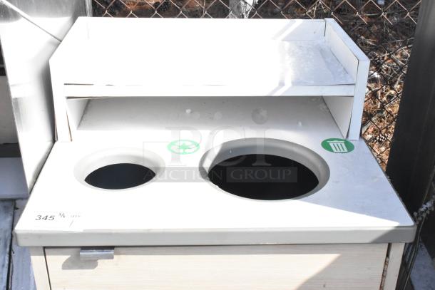 White trash can shell with two circular openings, recycling and trash icons. Top shelf, metal handle. Label reads "345 QTY."