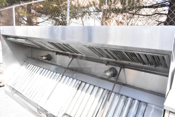 9.5' commercial return air grease hood with filters and lids, stainless steel, used condition, outdoor setting.