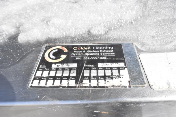 9.5' commercial return air grease hood with filters and lids, stainless steel, label by Golden Cleaning with cleaning dates.