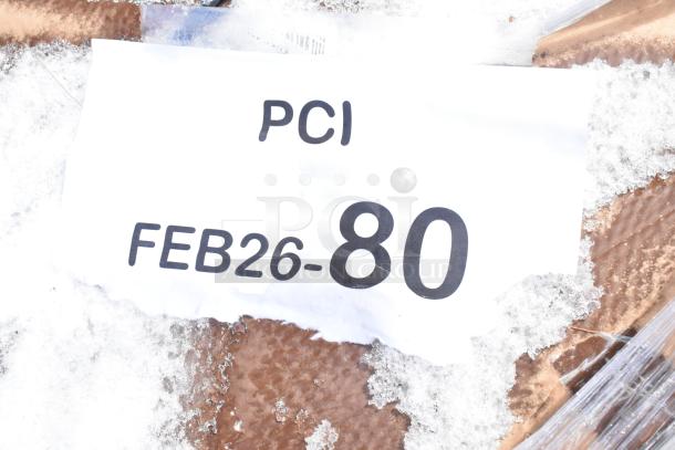Snow-covered package with tag reading "PCI FEB26-80." Contains 10 new scratch and dent items, including blinds and a work table.