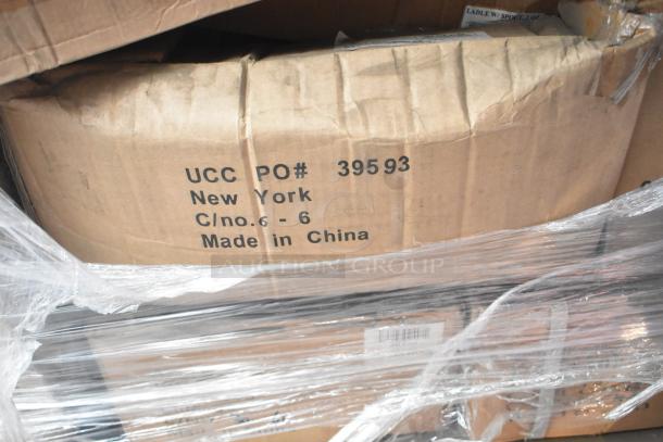 Cardboard box labeled "UCC PO# 39593 New York, Made in China," containing new scratch and dent kitchen items.