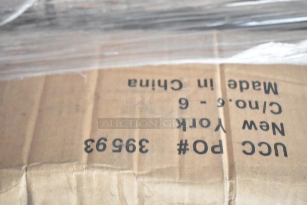 Cardboard box with markings: "UCC Po# 39593," "Made in China," "New York." Contains new scratch and dent items.