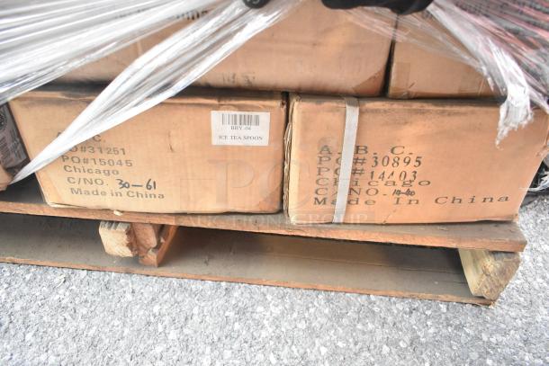 Pallet of 34 brand new scratch and dent items, including FG630400CLR Rubbermaid container, metal basket, cutlery. Labels visible.
