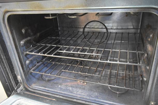 Kenmore 790.47873405 electric double wall convection oven, visible interior wear, 120/208-240 volts, broken glass noted.