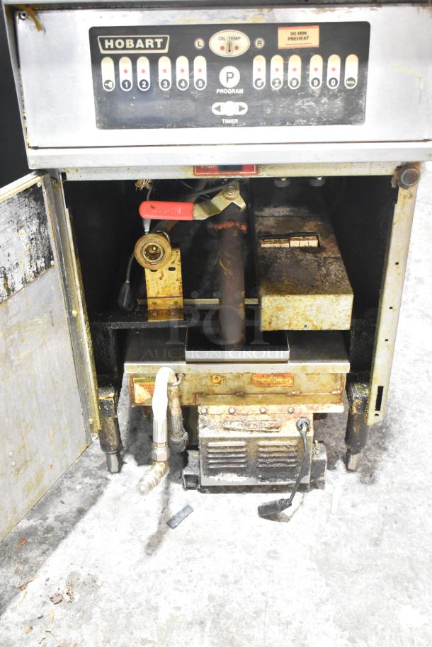 Hobart 1HF85C commercial electric deep fat fryer, 208 volts, worn condition with visible rust and wear marks, open front panel.