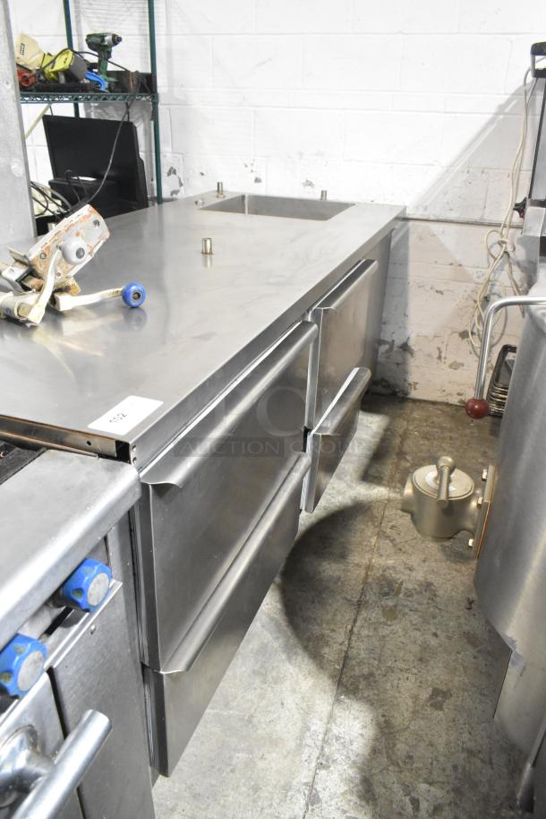 Commercial 4-drawer undercounter cooler with sink bay, 115 volts, 1 phase, stainless steel, used condition.