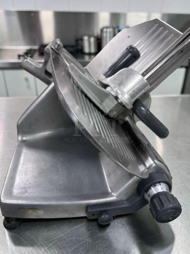 Hobart Commercial Manual Meat Slicer, NSF Listed, fully operational, made in USA, features precision dial and robust build.
