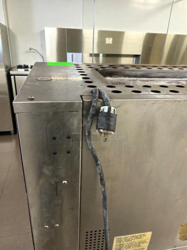 Duke Electric Conveyor Broiler Oven in immaculate condition, showing side view and plug; model DUK-L-BROIL-0527. Fully operational.