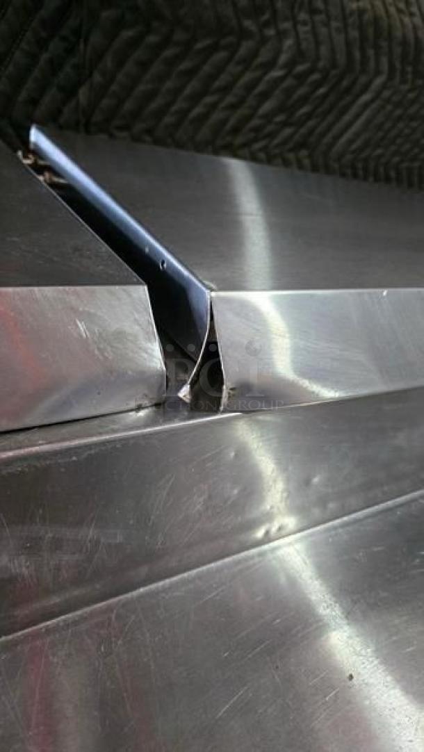 True TPP-93 three-door pizza prep refrigerator, stainless steel, showing close-up of damage on top edge, fully tested.