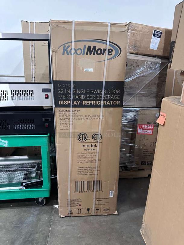 KoolMore MDR-9CP 22" single swing door merchandiser display refrigerator in box; brand new condition, ETL listed for commercial use.