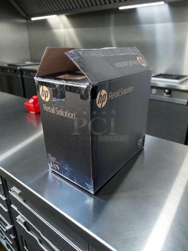 Brand new HP Engage One AIO POS System, Model 145, in sealed box, featuring UL listing and commercial touchscreen.