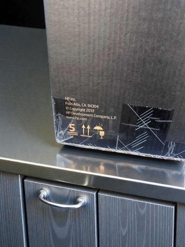 Brand new HP Engage One AIO POS System Model 145 box on counter. UL Listed, original packaging, copyright 2017.