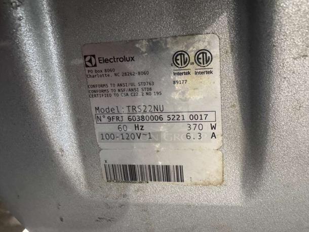 Robot Coupe TRS 22 food processor tag showing model TRS22NU, 370W, 60Hz, 100-120V, and manufacturer labels.