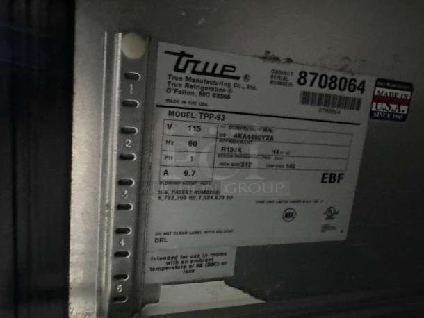 Label showing True Manufacturing Co. model TPP-93, 115V, 60Hz, USA-made, pristine condition, operational pizza prep table.