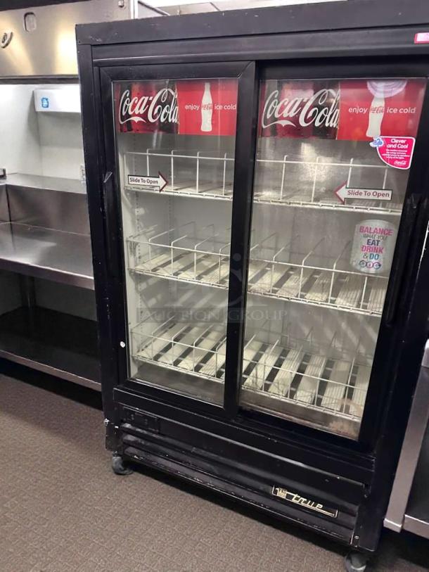 TRUE GDM-33SL-54EM-LD commercial glass door refrigerator, Coca-Cola branded, 54", black, UL listed, fully operational.
