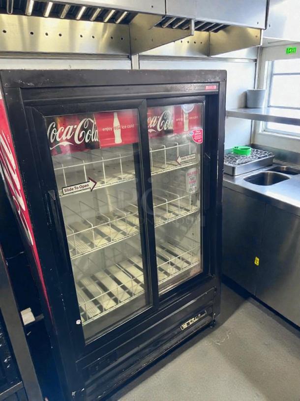 TRUE GDM-33SL-54EM-LD commercial glass door merchandiser refrigerator, 54", Coca-Cola branding, premium condition.