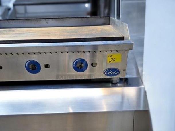 Commercial stovetop by Globe Food Equipment, model GG48G, stainless steel, with blue knobs and UL Listed tag. Lot 26 label.