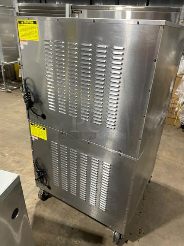 Vulcan commercial double-stacked convection oven, model SGD4D1, stainless steel, on casters, with wired rack, natural gas powered.