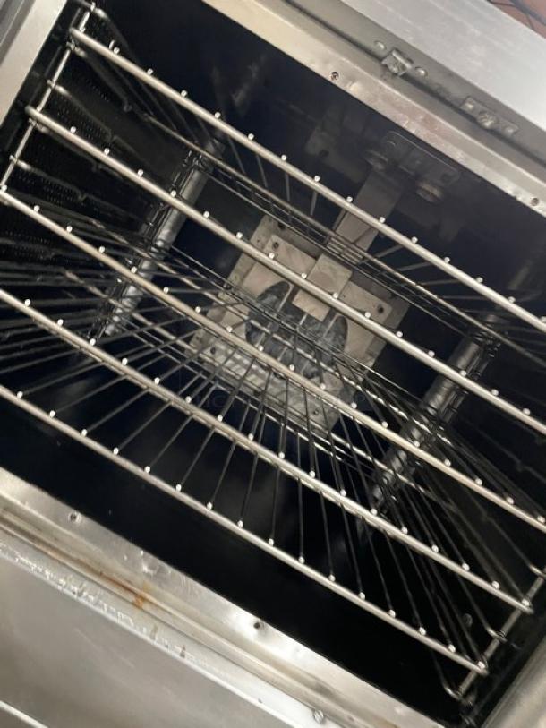 Vulcan SGD4D1 stainless steel double-stacked convection oven interior with wired rack, on casters, natural gas powered.