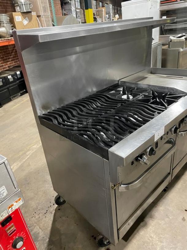 Southbend stainless steel gas-powered 6-burner range with split-top flat griddle, double oven, wavy grates, and salamander shelf.