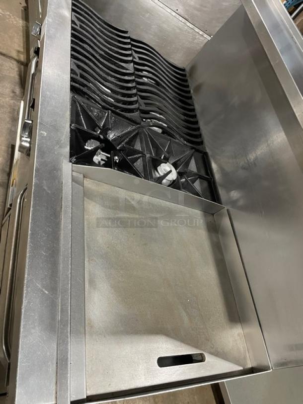 Southbend commercial 6-burner range with wavy grates, flat griddle, double oven, backsplash, salamander shelf, on casters.