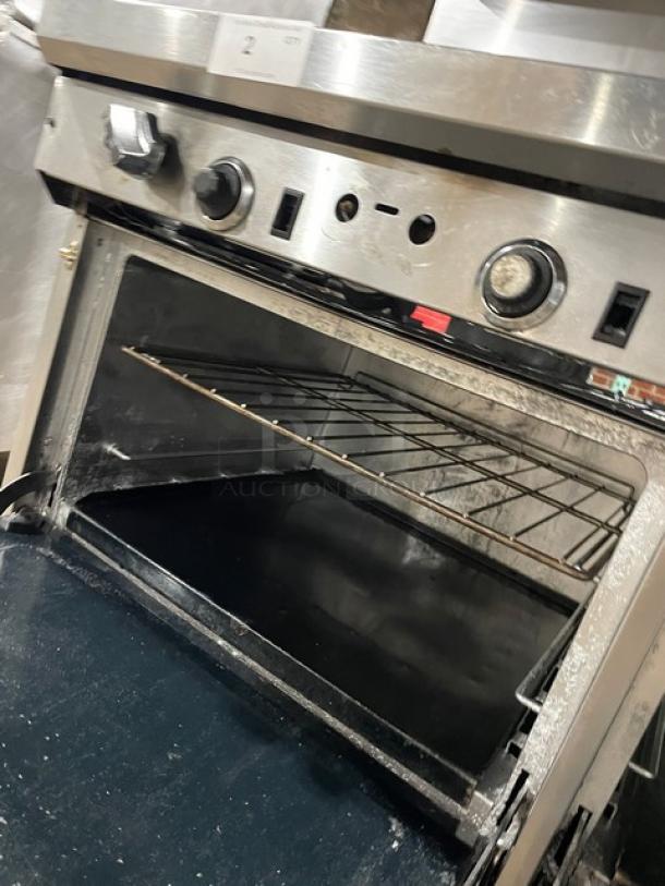 Southbend commercial stainless steel gas range with 6-burner split-top, flat griddle, double oven, and overhead salamander.