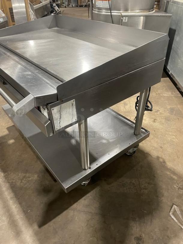 Vulcan stainless steel gas countertop flat top griddle on stand with casters, back & side splash, thermostatic control, 120V.