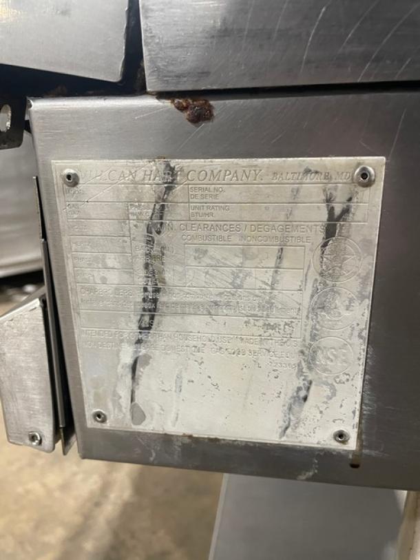 Vulcan stainless steel griddle, natural gas, on caster stand. Features back & side splash, thermostatic control. Visible label worn.