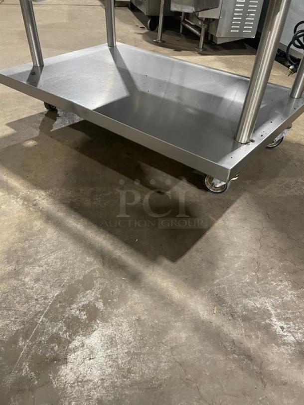 Vulcan stainless steel gas-powered countertop griddle on caster stand, with back and side splash, thermostatic control, 120V 1-phase.