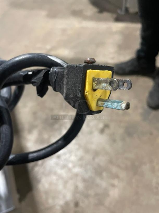 Close-up of a power plug for a Vulcan commercial griddle, showing a slightly worn yellow casing and prongs.