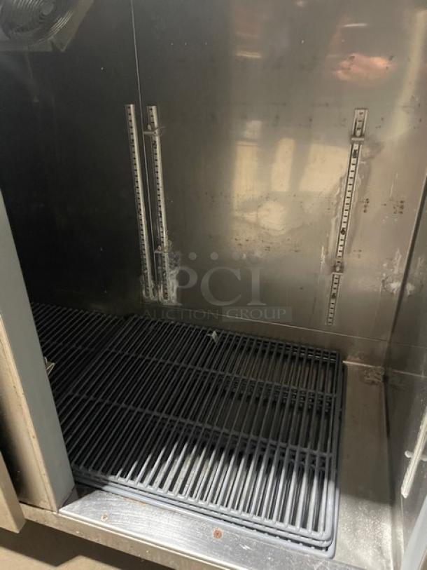 Perlick commercial stainless steel 4-door undercounter refrigerated cabinet. Features coated wired rack, SN: 518921, 115V 1 Phase.