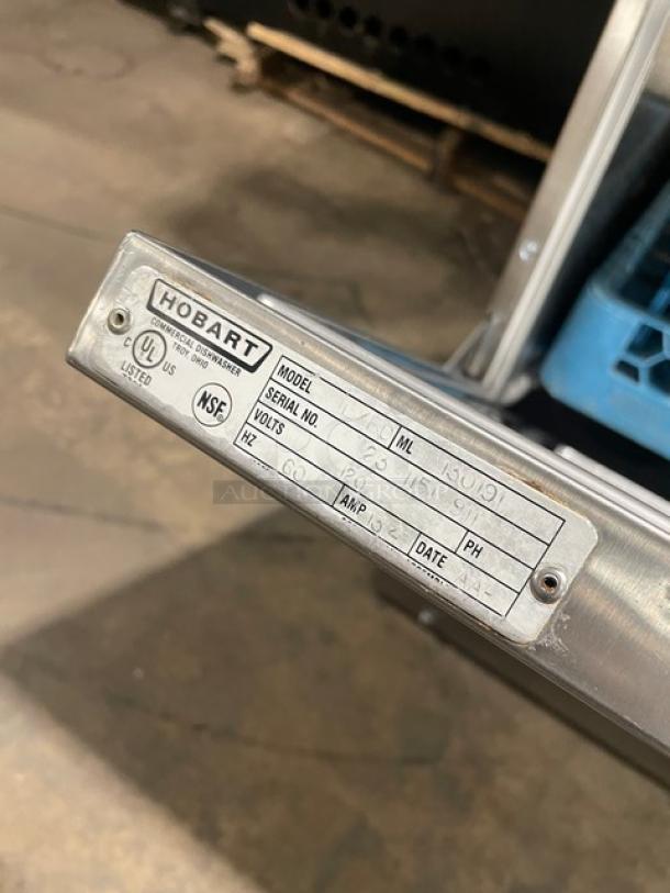 Hobart LXEC stainless steel undercounter dishwasher, model LXEC, with visible label showing NSF certification and serial number.