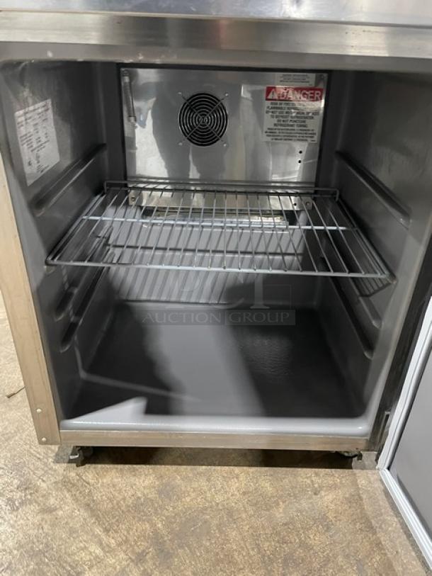Delfield commercial stainless steel undercounter refrigerator, Model 406P-STAR2, with coated wire rack and casters.