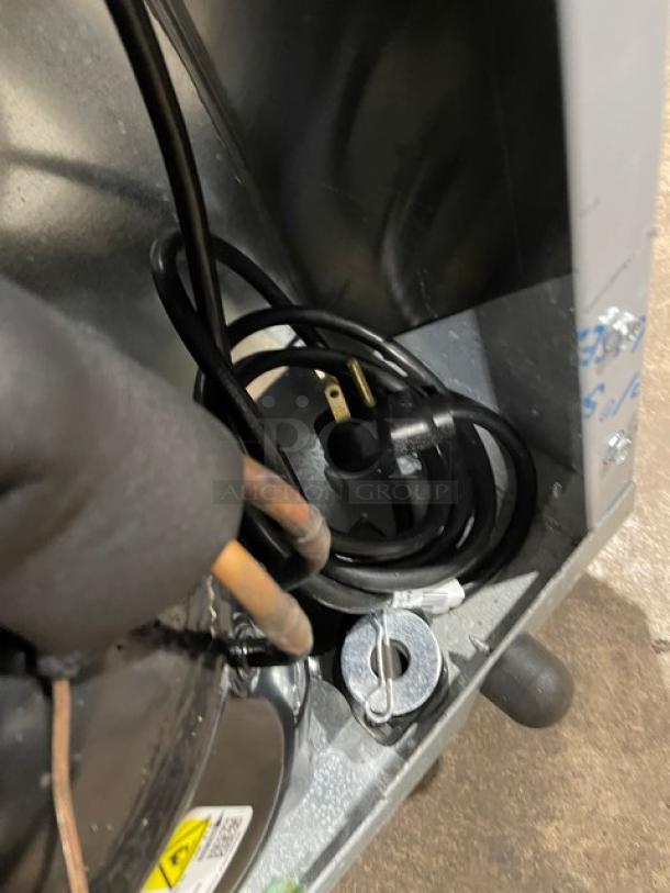 Power cord and internal view of a Delfield 406P-STAR2 stainless steel undercounter refrigerator, focusing on electrical components.