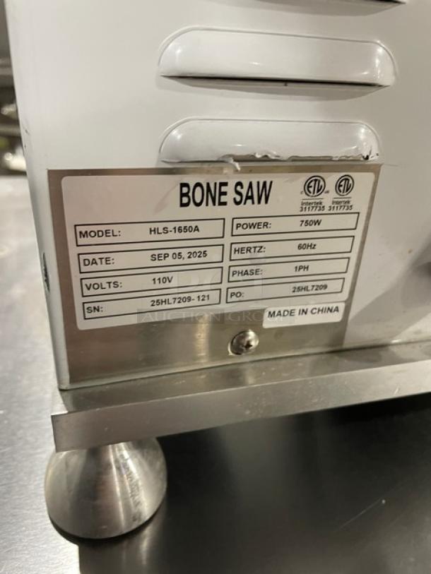 Universal HLS-1650A bone saw, anodized aluminum, electric, 110V, 1 phase, model and serial number label visible, on legs.