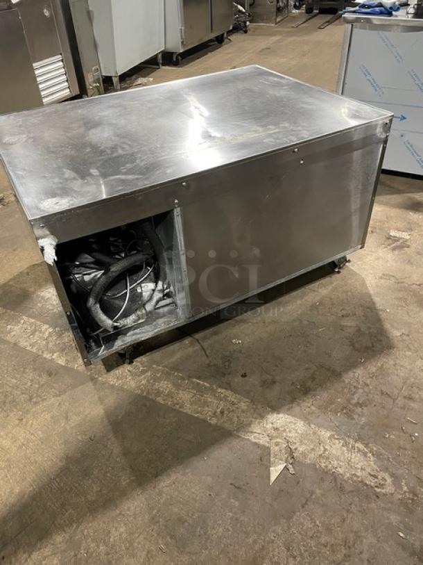 Continental stainless steel 2-drawer refrigerated chef base on casters, visible wear, exposed internal components, suitable for commercial use.