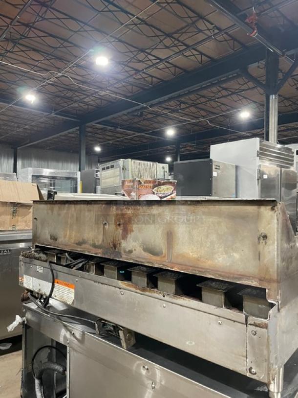 WoodStone stainless steel gas plancha flat griddle, split-top style, with back and side splash, on legs, used condition.