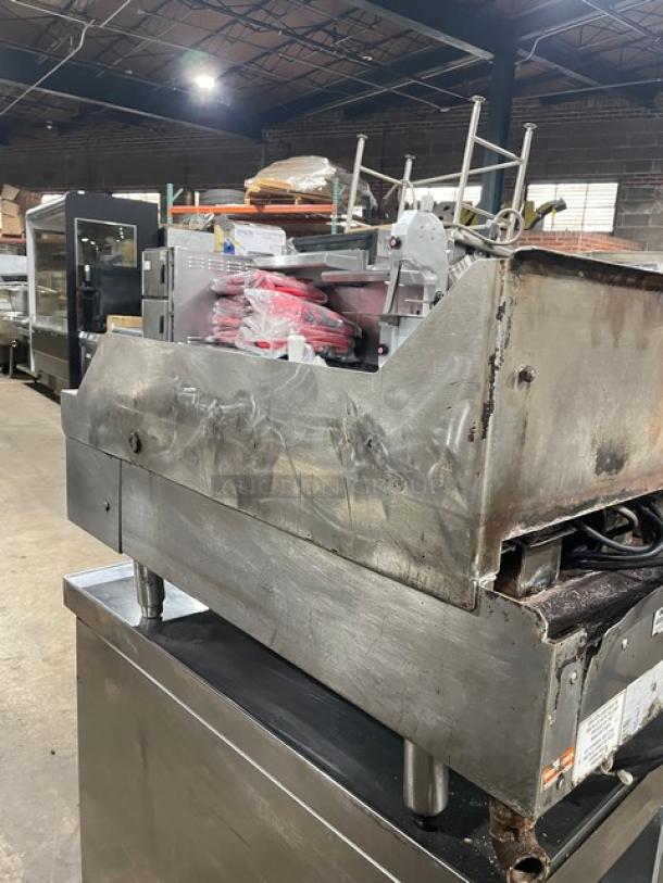 WoodStone commercial stainless steel gas-powered split-top plancha griddle with back and side splash, on legs, used condition.