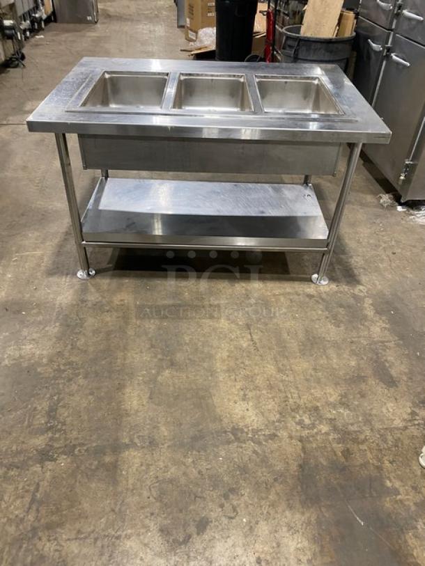 Wells MOD300TDM stainless steel 3-well hot food table with thermostatic controls, single undershelf, and legs, 208/240V.