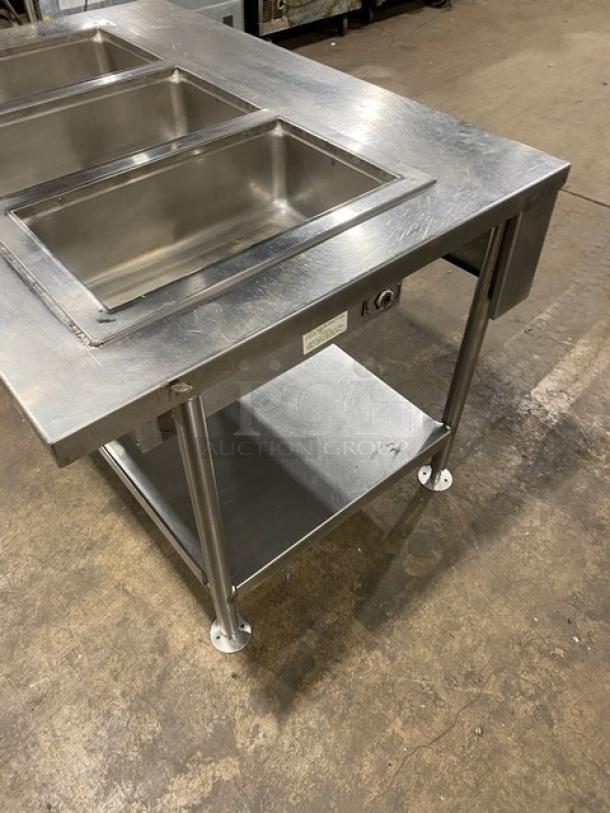 Wells MOD300TDM stainless steel 3-well hot food table with thermostatic controls, single undershelf, and legs.